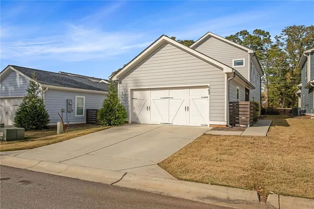 a view of a house with a yard and garage