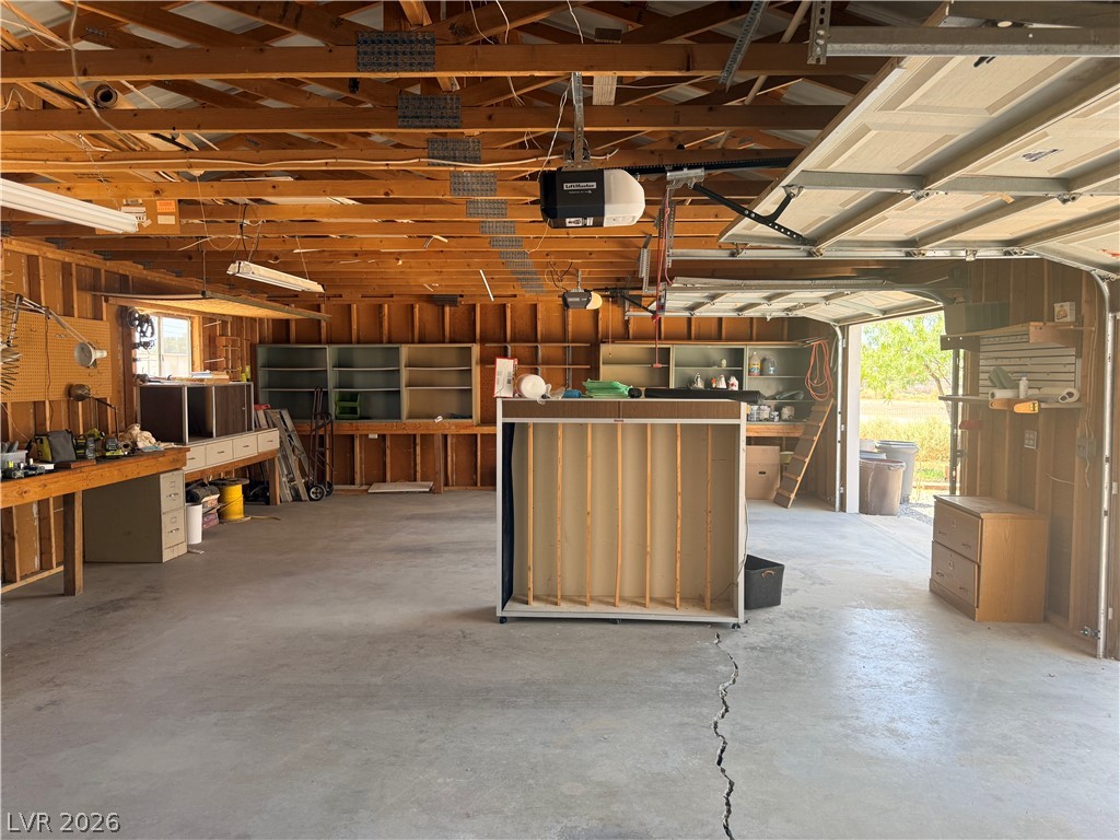 1391 West Dyer Road Pahrump, NV 89048 - Photo 17 of 50 Ample workspace and storage solutions define this expansive garage, ready for projects.