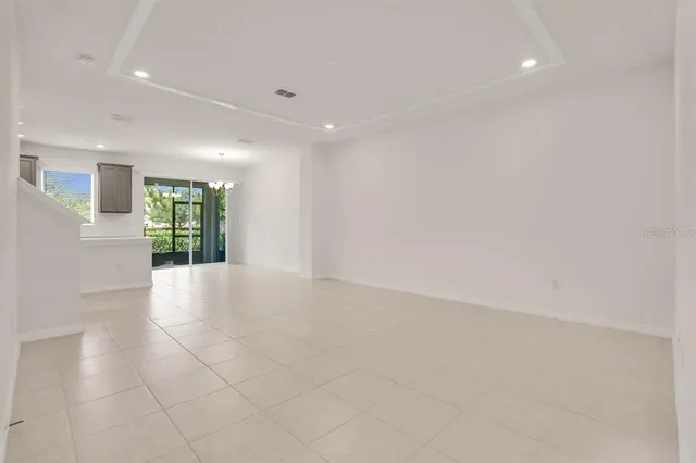 an empty room with staircase and white walls