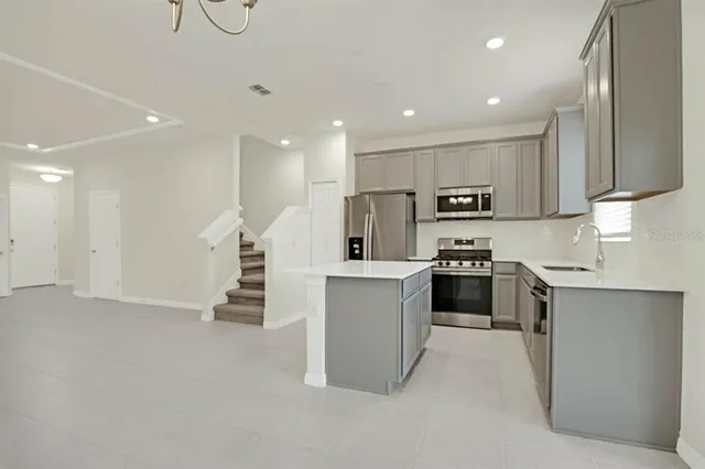 a bedroom with a large bed and a flat tv screen on dresser