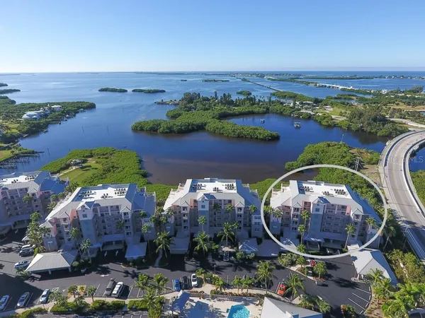 an aerial view of a house with a garden and lake view