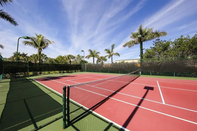 a tennis court with view of outdoor space