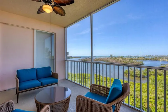 a balcony with furniture and a potted plant