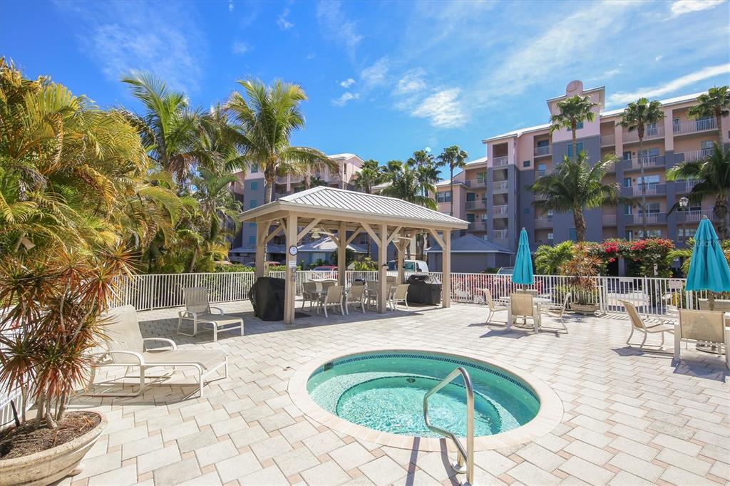 13113 Gasparilla Road, Unit 503 Placida, FL 33946 - Photo 17 of 18 a swimming pool with outdoor seating and yard