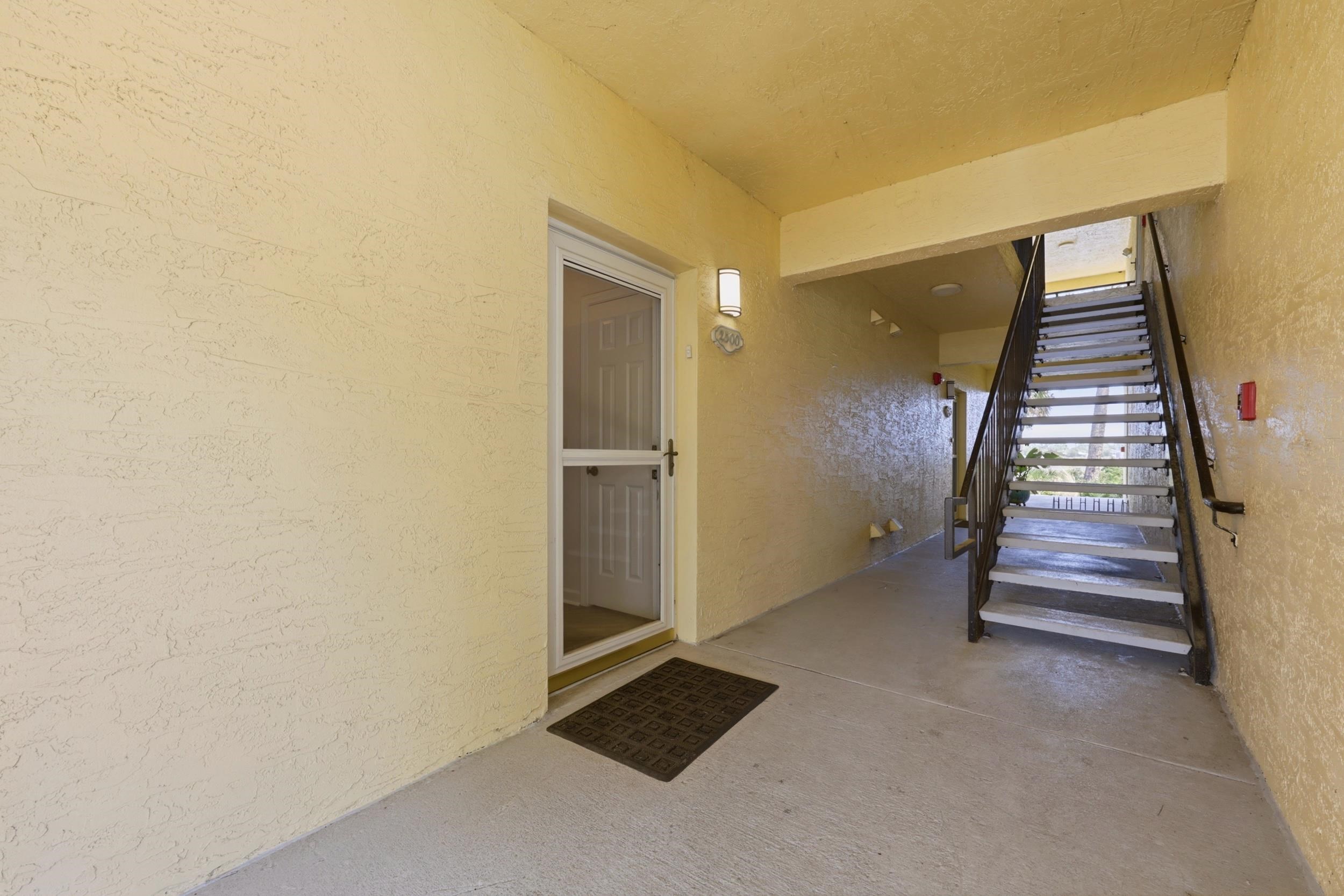 2500 Vista Cove Road St. Augustine, FL 32084 - Photo 3 of 53 an empty room with staircase and white walls