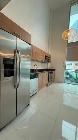 a kitchen with stainless steel appliances granite countertop a refrigerator and a stove