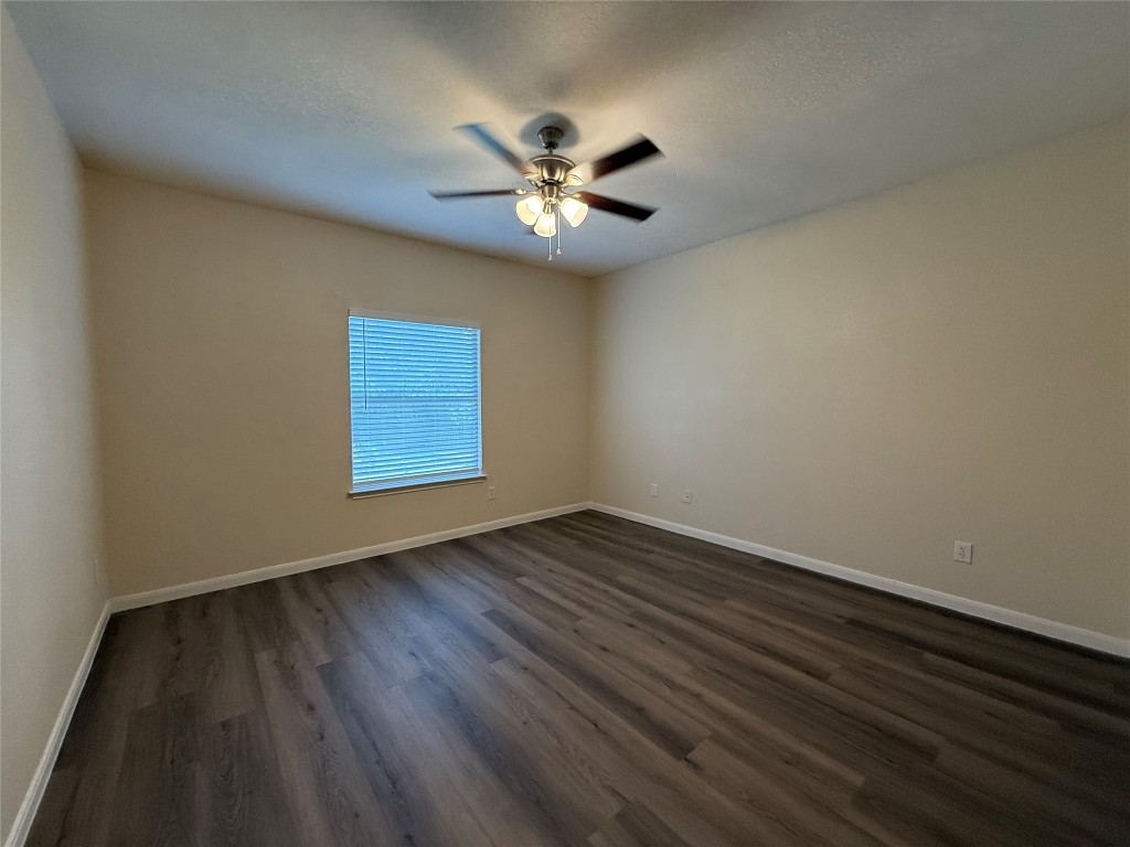 303 Kates Way Hutto, TX 78634 - Photo 7 of 15 a view of an empty room with window and wooden floor