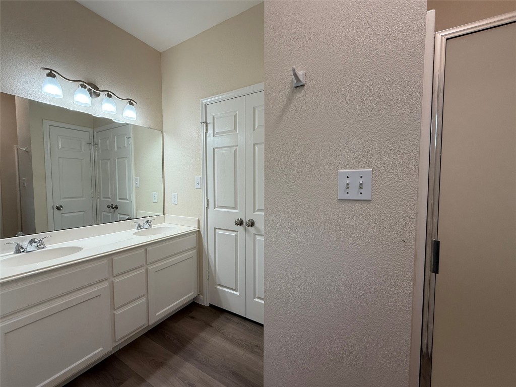 303 Kates Way Hutto, TX 78634 - Photo 9 of 15 a spacious bathroom with a double vanity sink and mirror