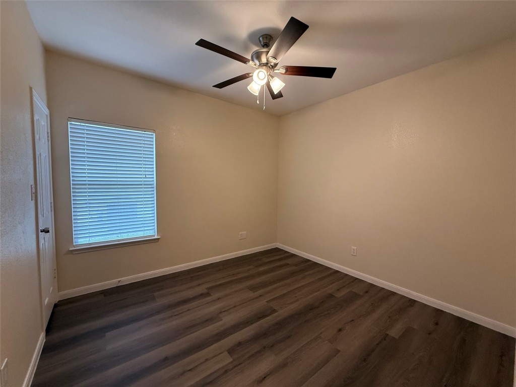 303 Kates Way Hutto, TX 78634 - Photo 10 of 15 a view of wooden floor and a chandelier fan in a room
