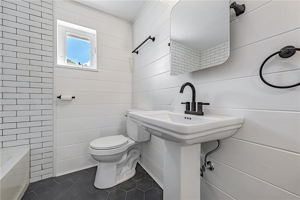 13850 Ridge Road North Huntingdon, PA 15642 - Photo 10 of 21 a bathroom with a sink a toilet and mirror
