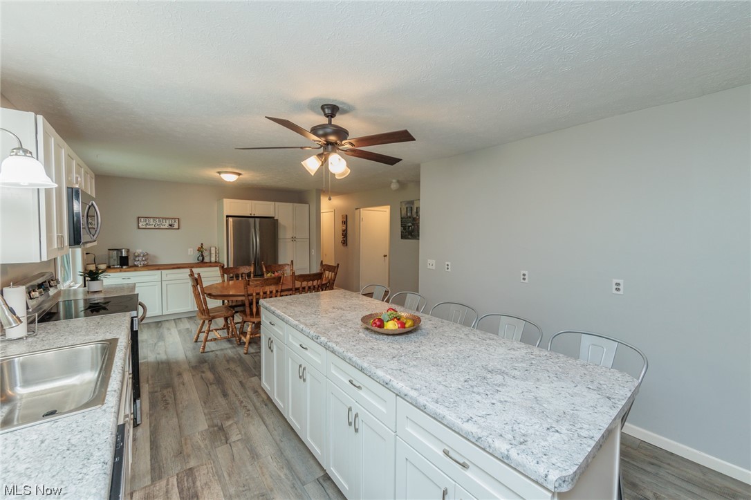4560 Winchell Road Mantua, OH 44255 - Photo 7 of 35 White Kitchen w/LVP Wood Floor.