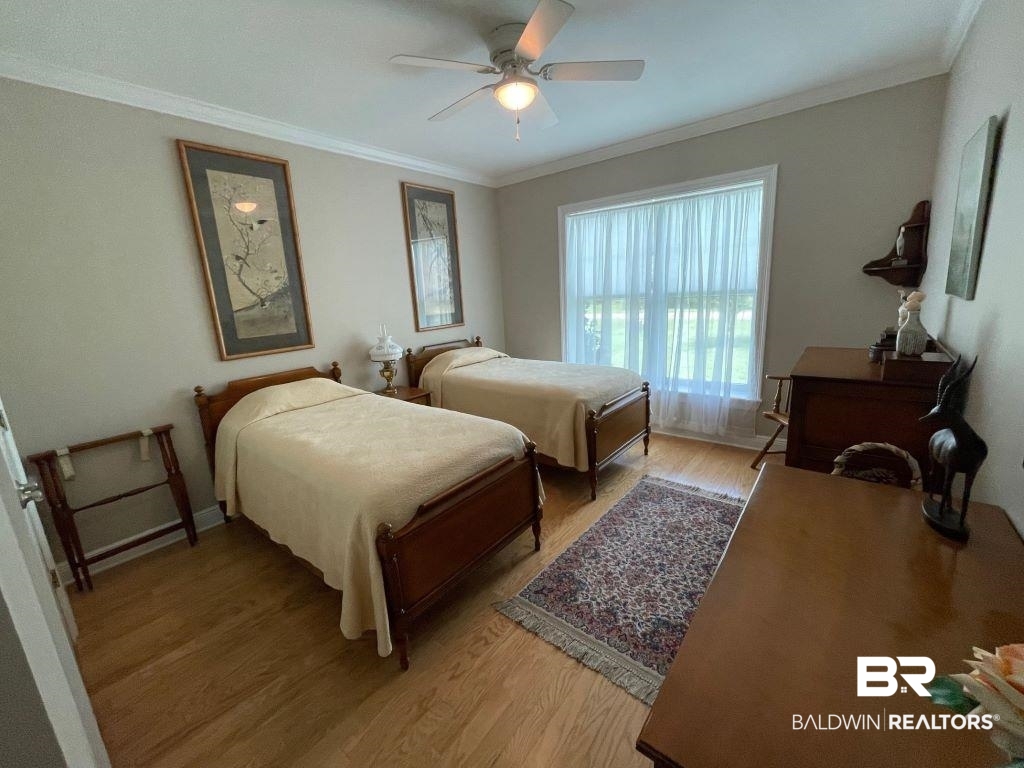 6426 East Quarry Drive Elberta, AL 36530 - Photo 11 of 19 Bedroom featuring light hardwood / wood-style floors, ornamental molding, and ceiling fan