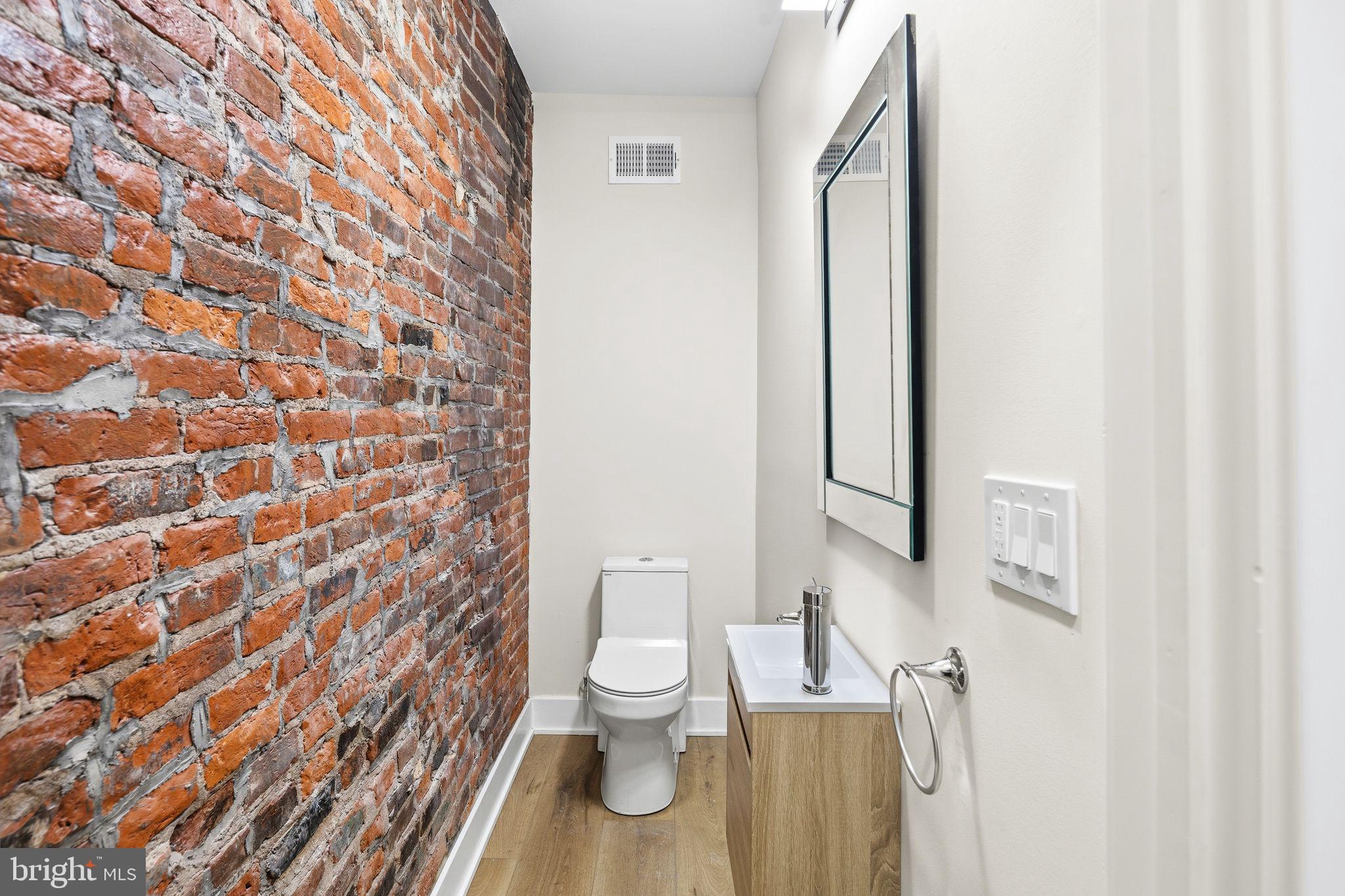 1731 Reed Street Philadelphia, PA 19146 - Photo 12 of 42 a bathroom with a toilet and a shower curtain