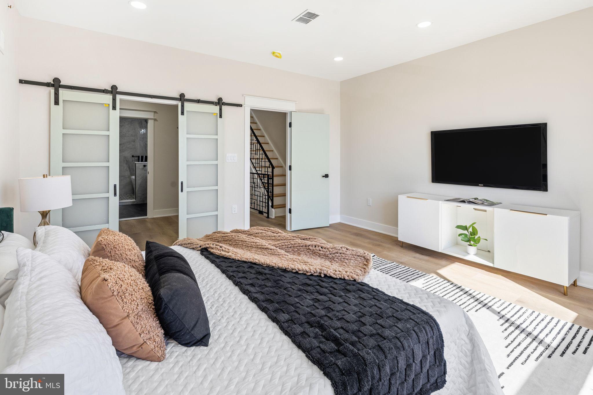 1731 Reed Street Philadelphia, PA 19146 - Photo 16 of 42 a bedroom with a bed and a flat screen tv