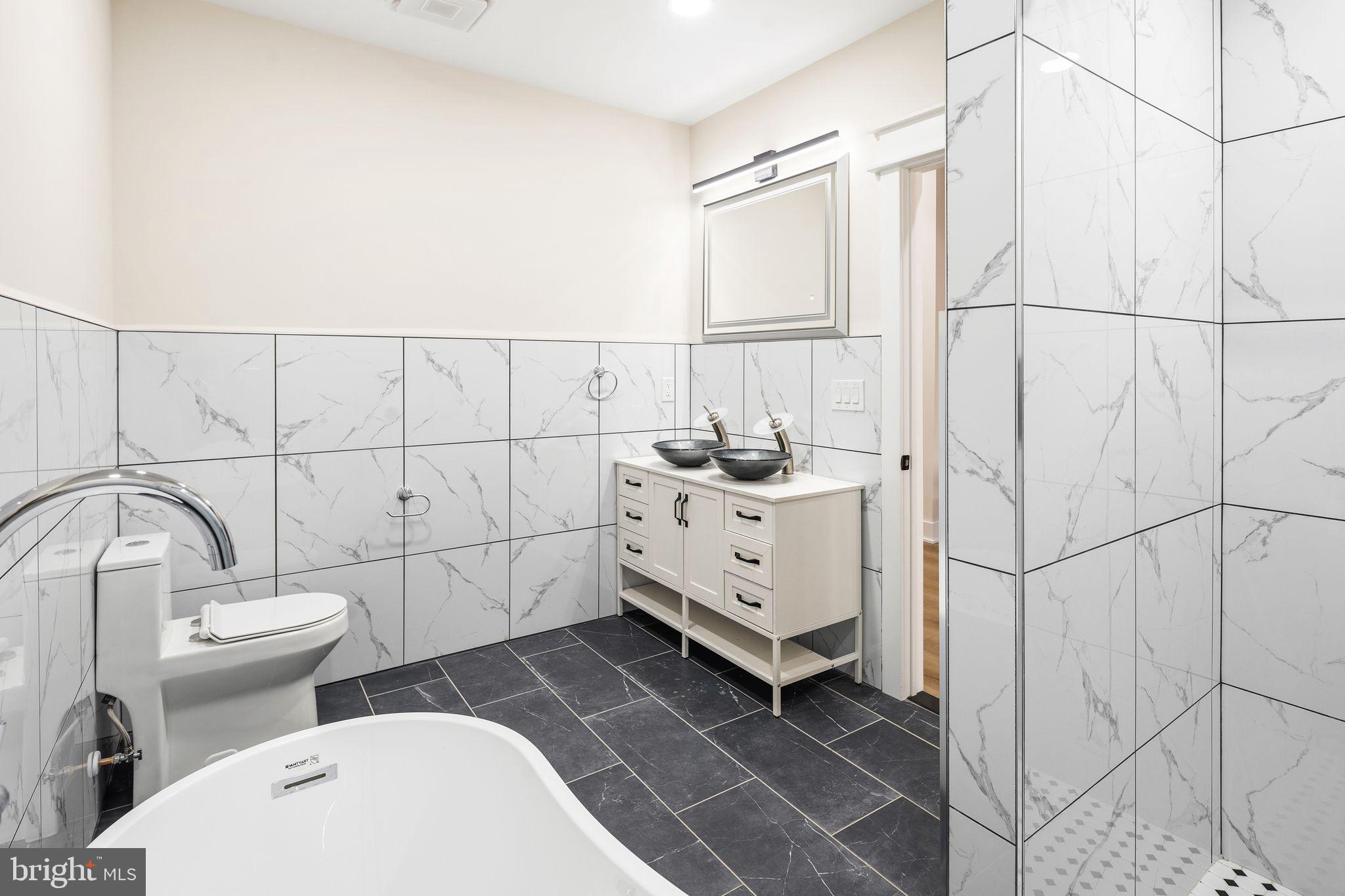 1731 Reed Street Philadelphia, PA 19146 - Photo 29 of 42 a bathroom with a toilet sink and mirror