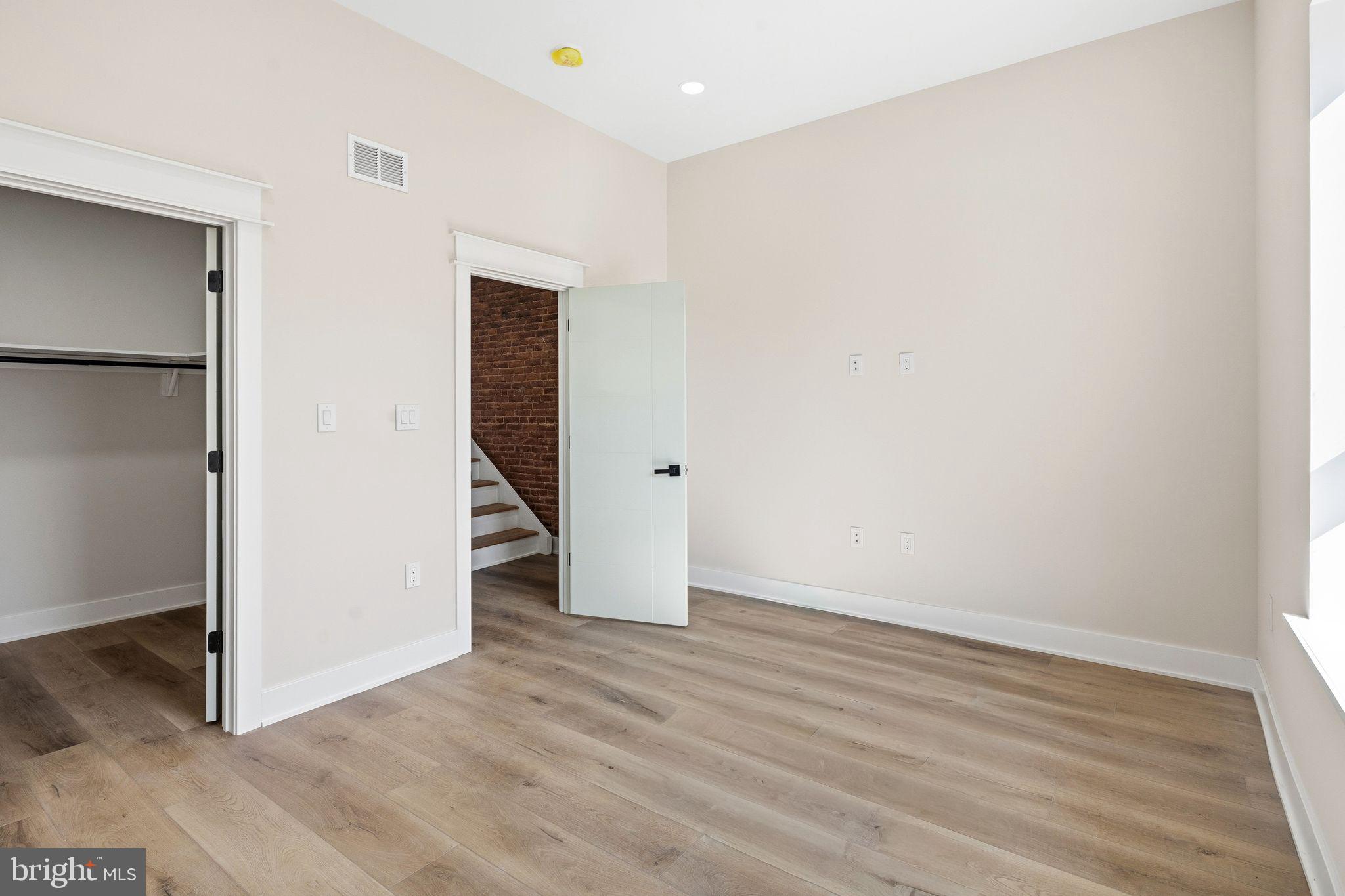 1731 Reed Street Philadelphia, PA 19146 - Photo 33 of 42 an empty room with wooden floor & entryway