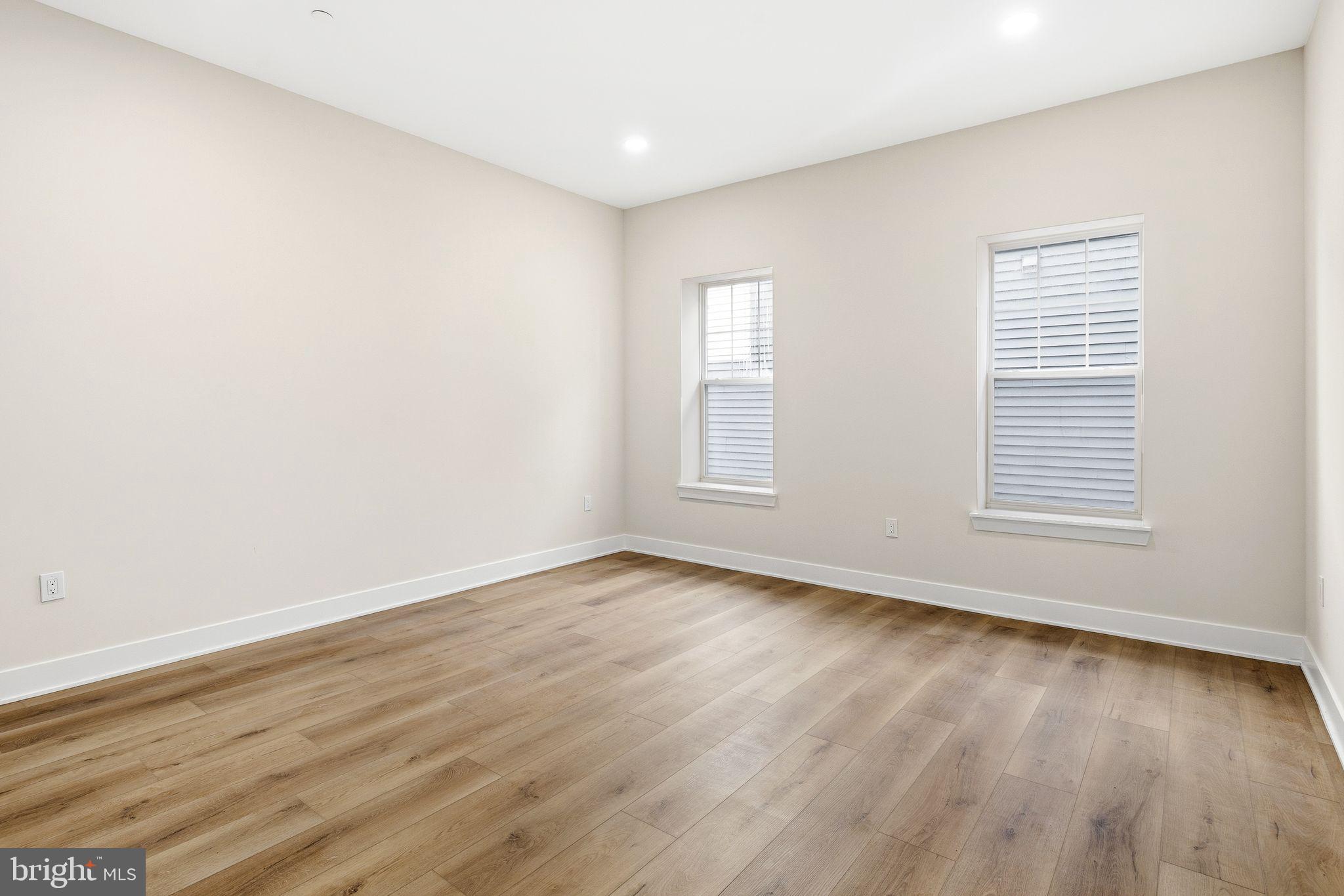 1731 Reed Street Philadelphia, PA 19146 - Photo 35 of 42 an empty room with wooden floor and windows