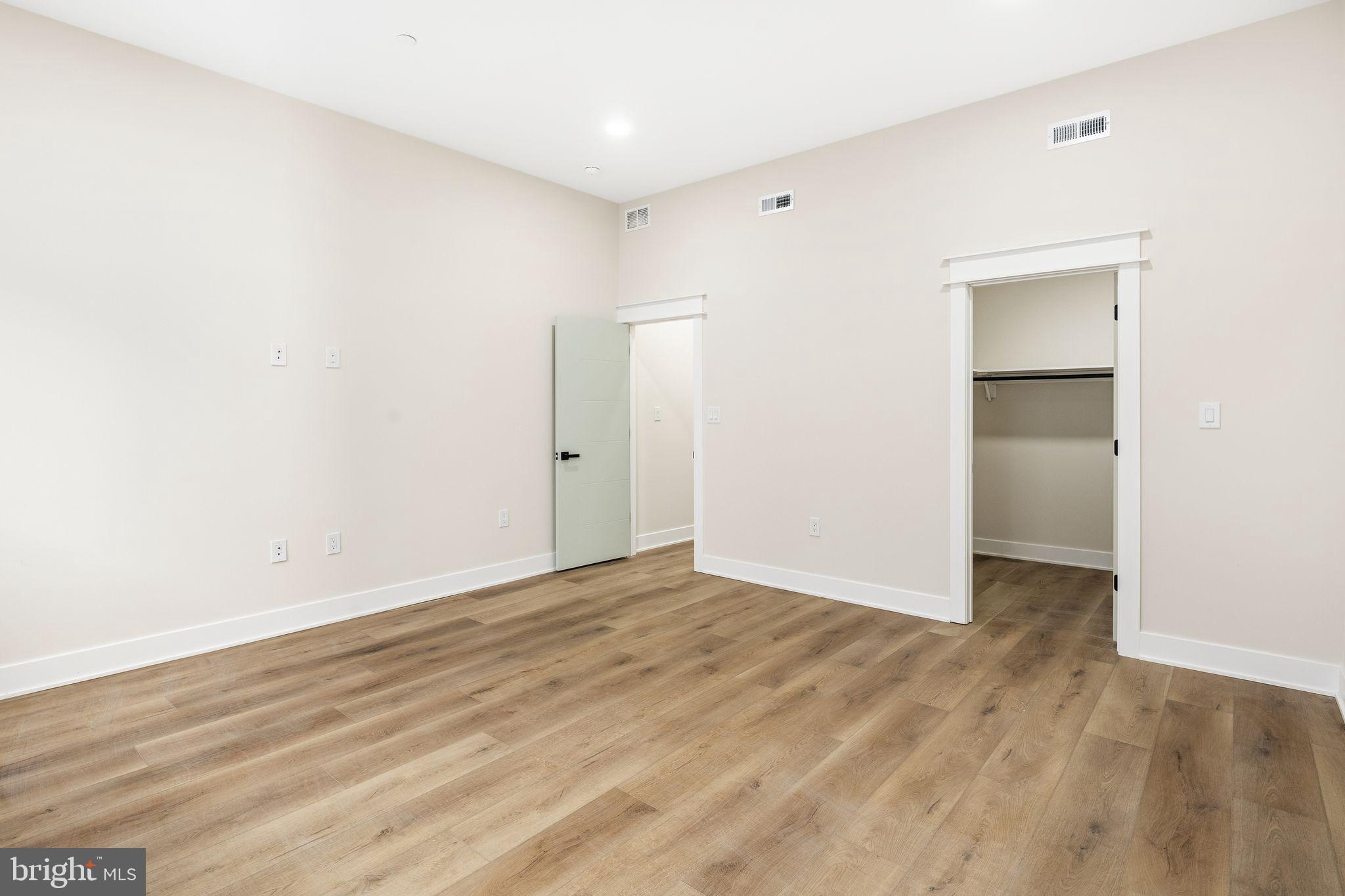 1731 Reed Street Philadelphia, PA 19146 - Photo 36 of 42 an empty room with wooden floor & closet and windows