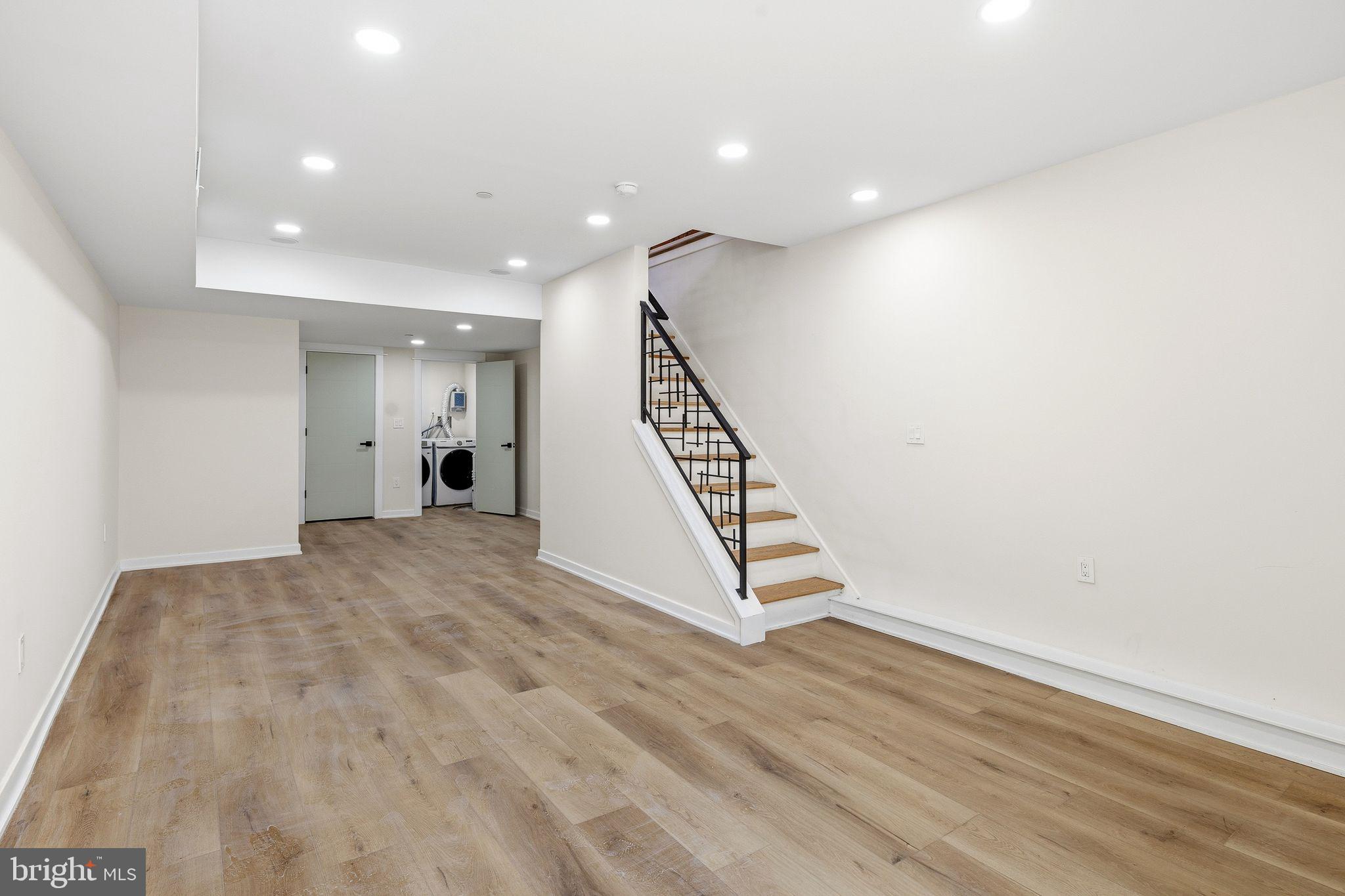1731 Reed Street Philadelphia, PA 19146 - Photo 39 of 42 a view of an empty room with wooden floor and stairs