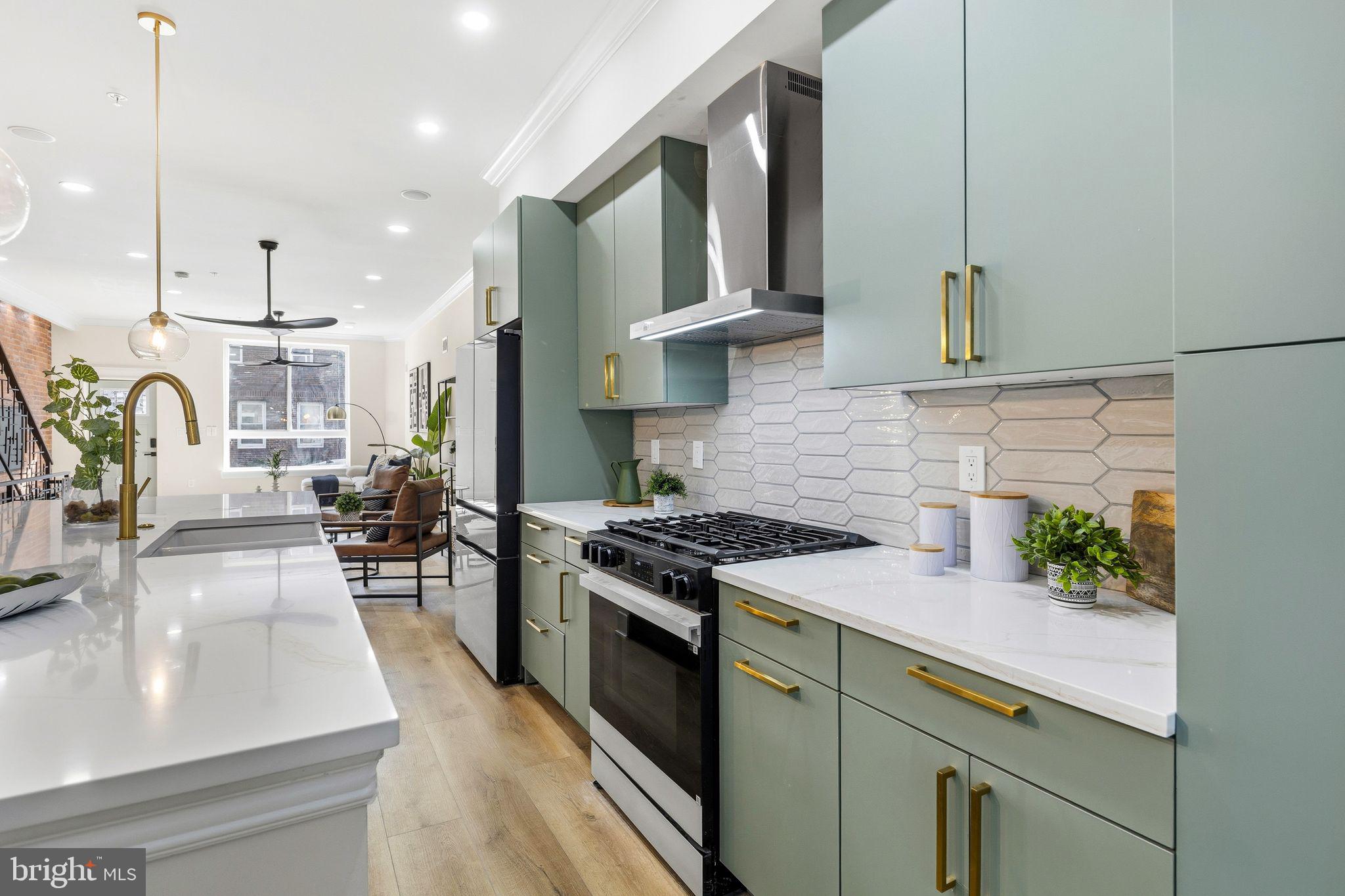 1731 Reed Street Philadelphia, PA 19146 - Photo 9 of 42 a kitchen with stainless steel appliances granite countertop a stove a sink and a refrigerator
