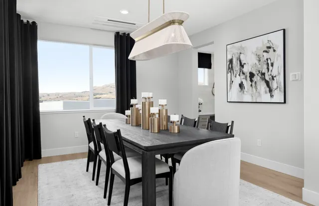 a view of a dining room with furniture and window
