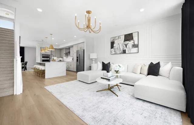 a living room with furniture and kitchen view