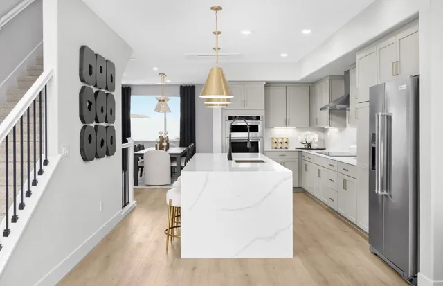 a kitchen with white cabinets and stainless steel appliances