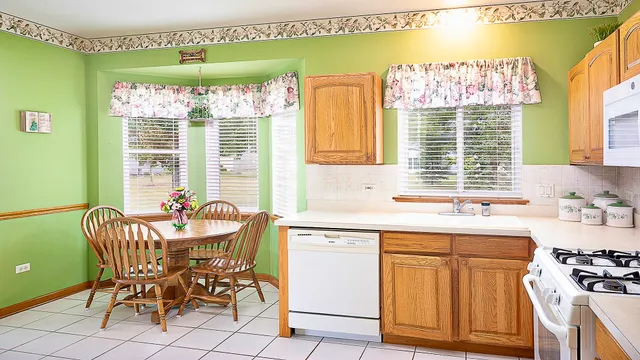 a kitchen with a table chairs and a sink
