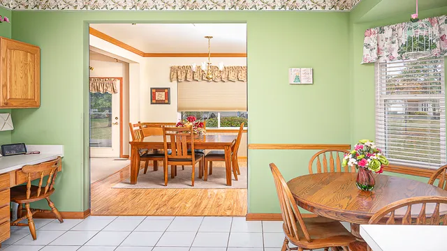 a dining room with furniture and wooden floor