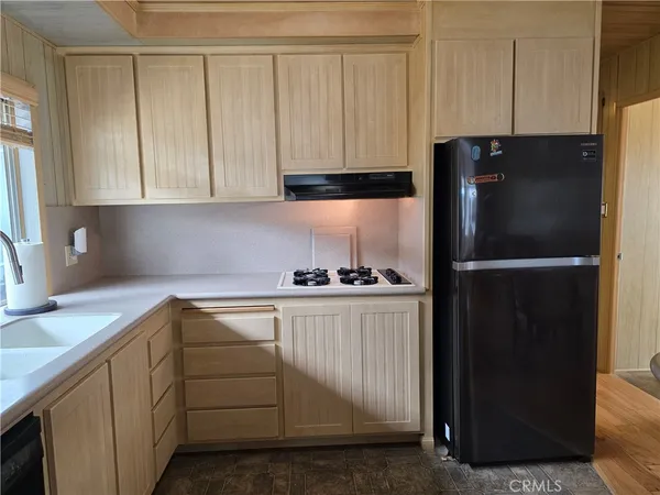 a kitchen with a refrigerator and cabinets