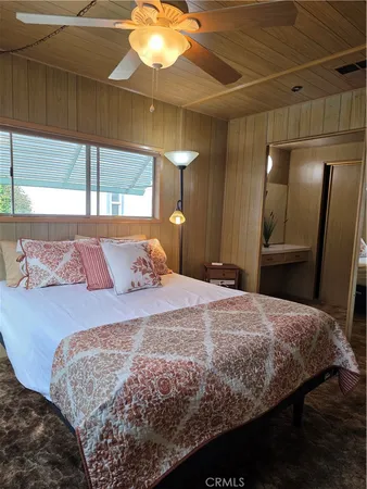 a bedroom with a large bed and a chandelier
