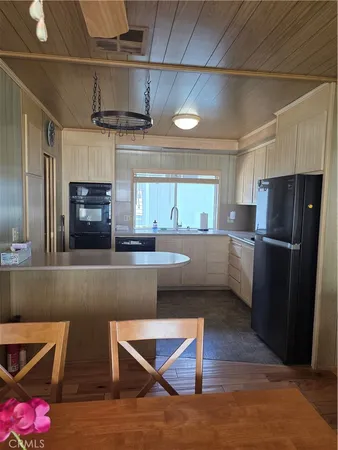 a kitchen with refrigerator and microwave