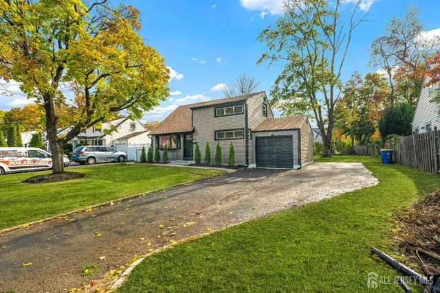 a view of a house with a yard and tree s