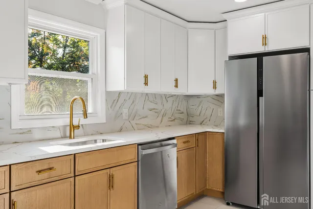 a kitchen with stainless steel appliances white cabinets and a stove top oven