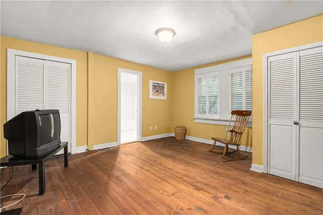 a view of a livingroom with workspace and a window