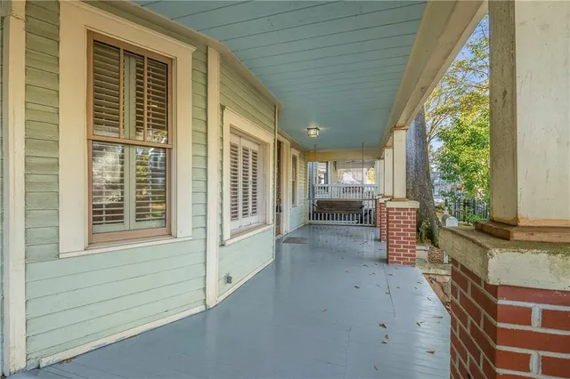 a view of a porch with wooden floor and iron stairs