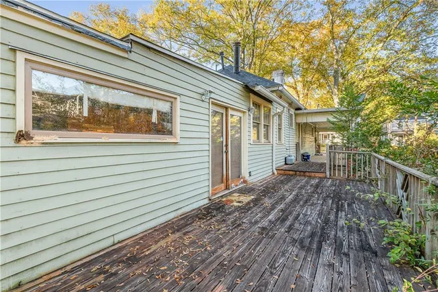 a view of backyard with deck and wooden floor