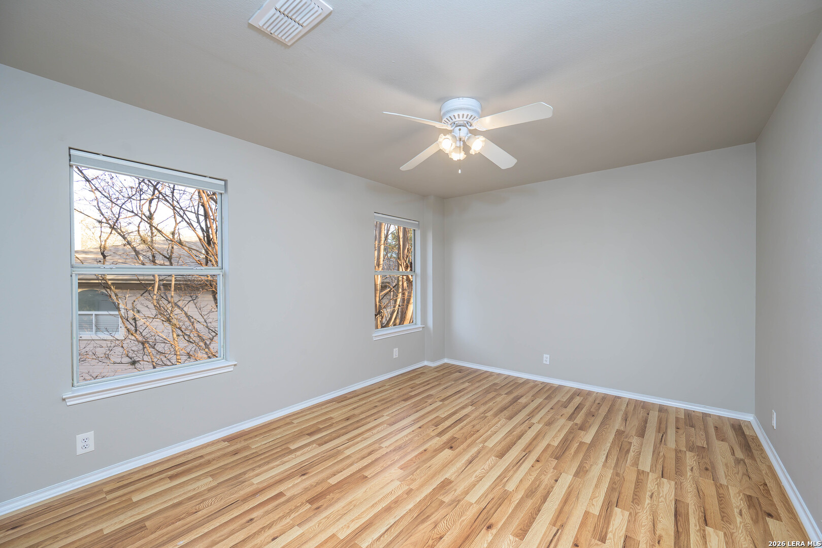 16558 Redland Ranch San Antonio, TX 78247 - Photo 11 of 17 a view of room with window ceiling fan and wooden floor