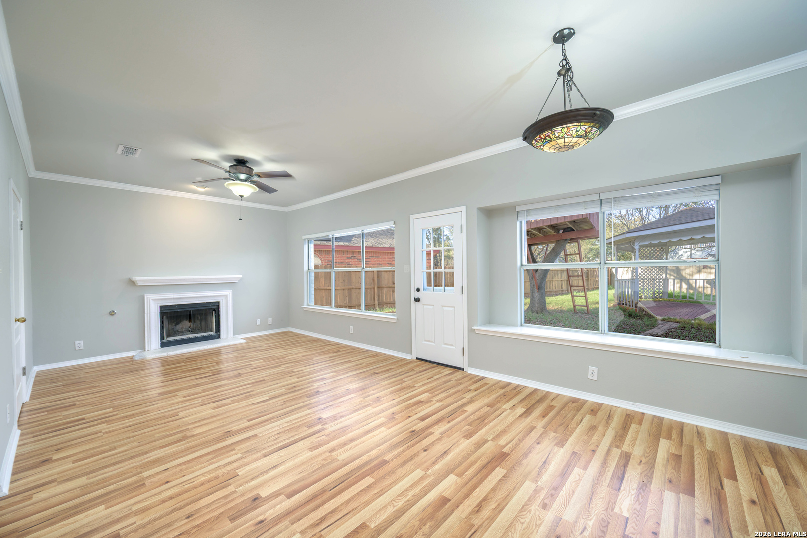16558 Redland Ranch San Antonio, TX 78247 - Photo 2 of 17 a view of empty room with wooden floor and fireplace