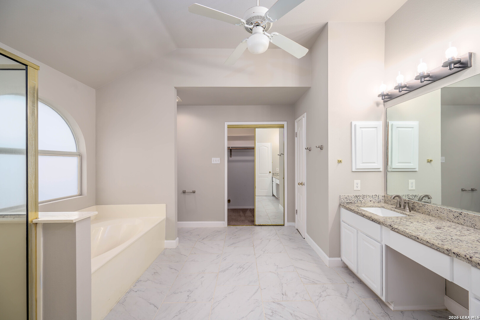 16558 Redland Ranch San Antonio, TX 78247 - Photo 7 of 17 a bathroom with a granite countertop sink a mirror and a bathtub