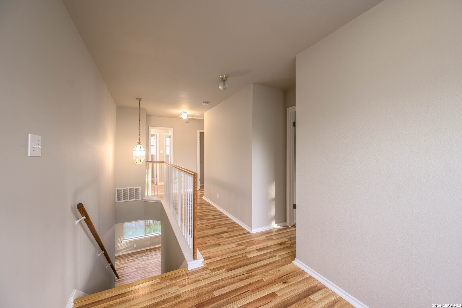 16558 Redland Ranch San Antonio, TX 78247 - Photo 8 of 17 a view of a hallway with wooden floor and staircase