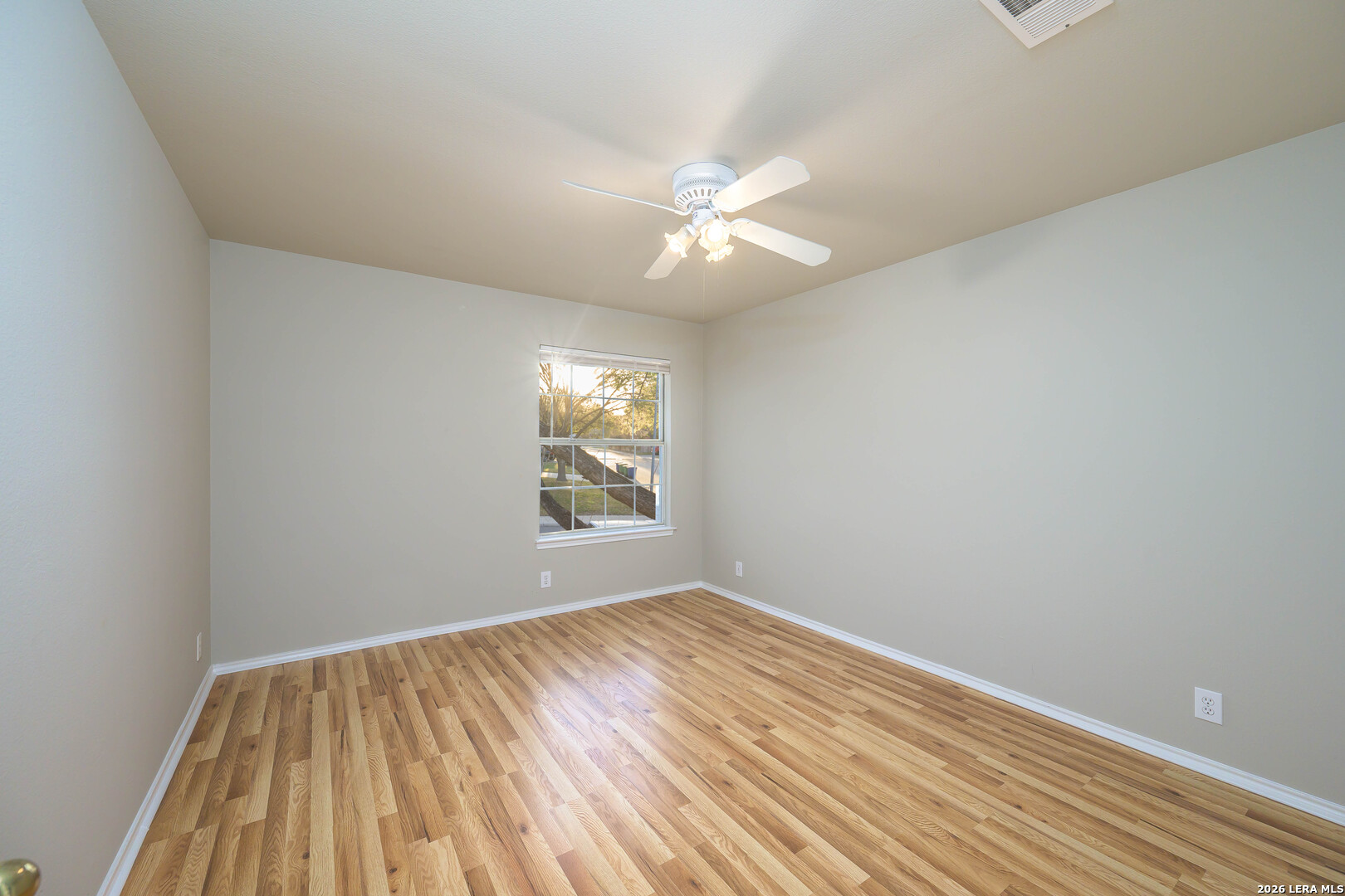 16558 Redland Ranch San Antonio, TX 78247 - Photo 10 of 17 wooden floor in an empty room with a window