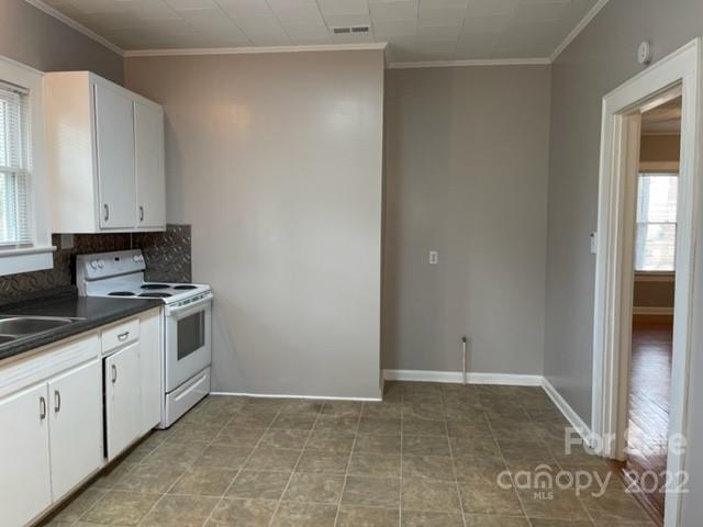 449 15th Street Southwest Hickory, NC 28602 - Photo 5 of 11 a kitchen with granite countertop white cabinets and white appliances