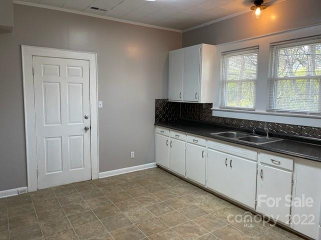 449 15th Street Southwest Hickory, NC 28602 - Photo 6 of 11 a kitchen with granite countertop white cabinets and sink