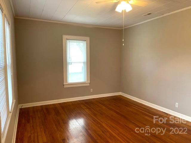 449 15th Street Southwest Hickory, NC 28602 - Photo 8 of 11 a view of an empty room with wooden floor and a window