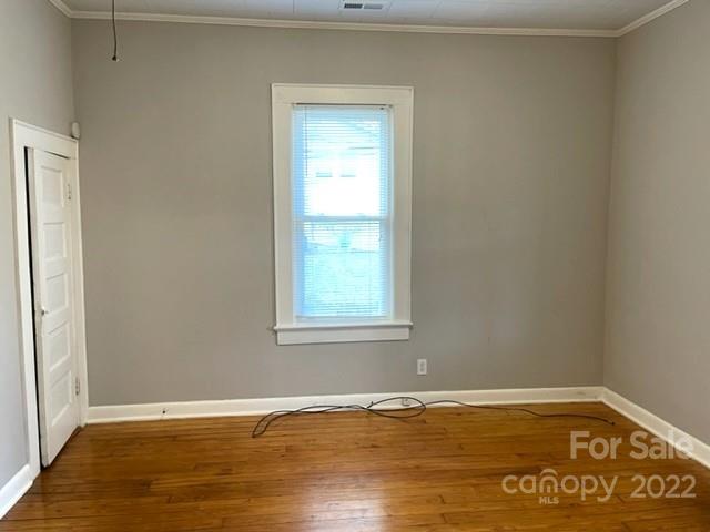 449 15th Street Southwest Hickory, NC 28602 - Photo 10 of 11 a view of an empty room with wooden floor and a window