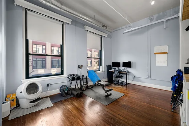 a view of a workspace with furniture and a window