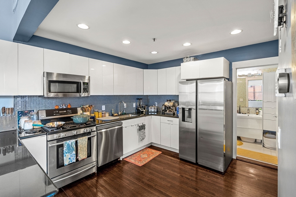 70 Exchange Street, Unit 206 Lynn, MA 01901 - Photo 6 of 40 a kitchen with stainless steel appliances granite countertop a refrigerator a stove a sink and a microwave