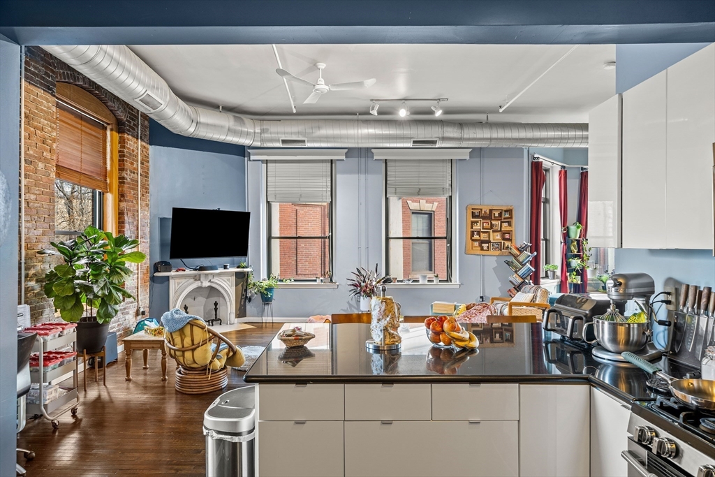 70 Exchange Street, Unit 206 Lynn, MA 01901 - Photo 9 of 40 a living room with furniture and a flat screen tv