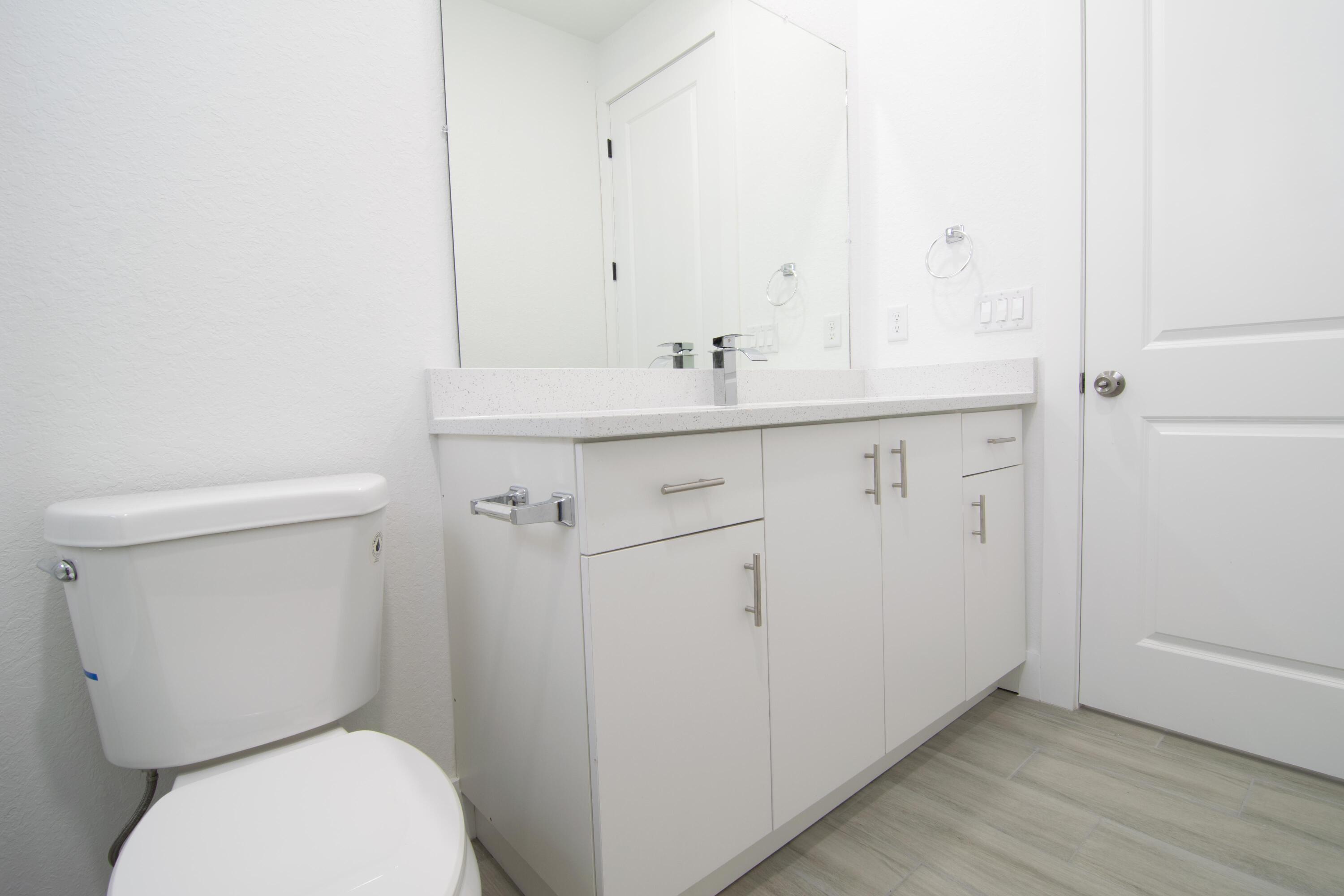 10654 Washington Road Port Charlotte, FL 33981 - Photo 15 of 36 a bathroom with a toilet sink and mirror